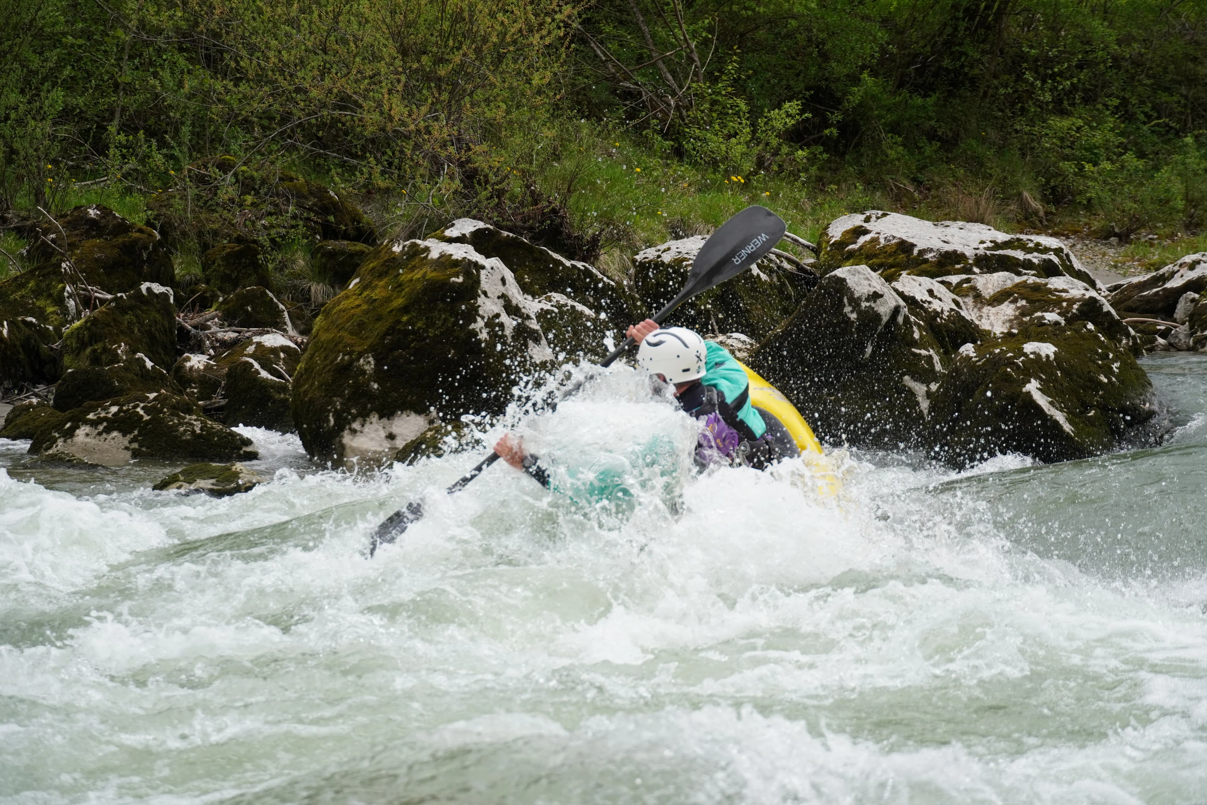Kayakers on an alpine whitewater river